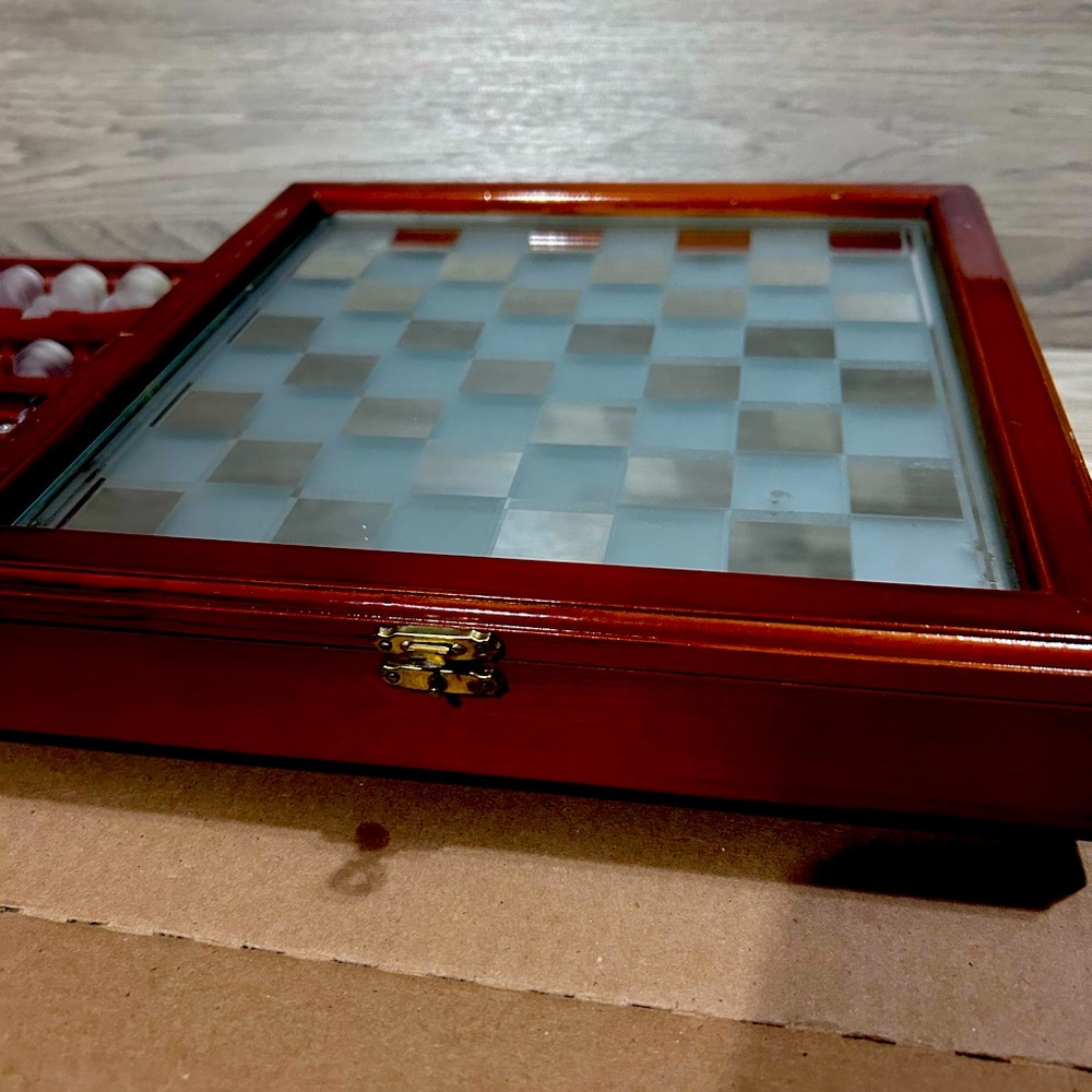 Glass chess set with wooden case and mirror playing board. Checkers included